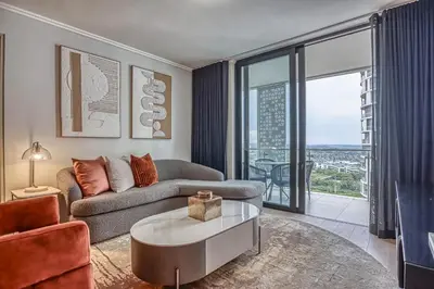 a living room with a couch and a table at Belle Vue at Ellipse in Midrand