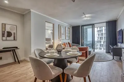 a living room with a table and chairs at Belle Vue at Ellipse in Midrand