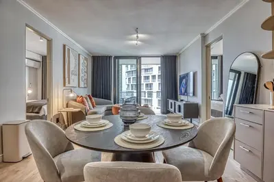 a living room with a table and chairs at Belle Vue at Ellipse in Midrand