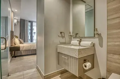 a bathroom with a sink and a mirror at Belle Vue at Ellipse in Midrand