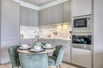 a kitchen with a table with chairs and a microwave at Bella Vista at Ellipse in Midrand