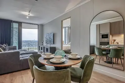 a living room with a table and chairs at Bella Vista at Ellipse in Midrand