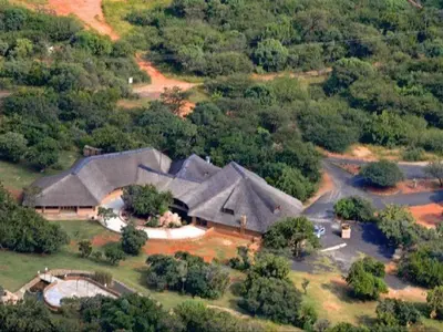 an aerial view of a large house in a forest at Out of Africa Lodge in Hartbeespoort