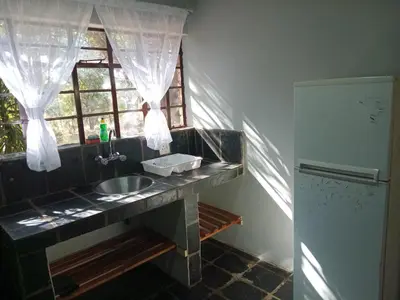 a kitchen with a sink and a window at Out of Africa Lodge in Hartbeespoort