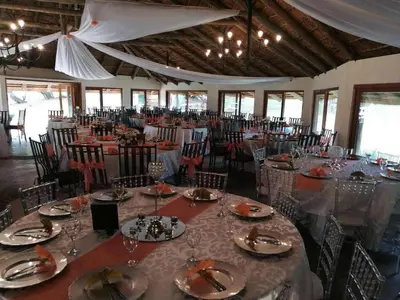 a large banquet hall with tables and chairs at Out of Africa Lodge in Hartbeespoort