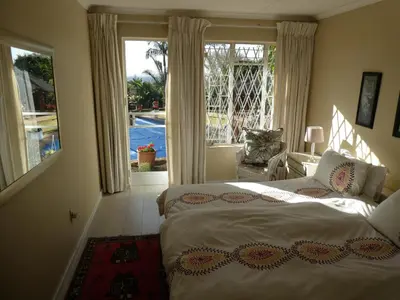 a bedroom with two beds and a view of a pool at Viva-Africa Zehetleitner in Pretoria