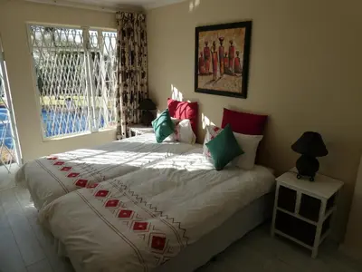 a large bed in a bedroom with a window at Viva-Africa Zehetleitner in Pretoria