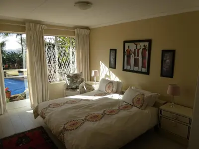 a bedroom with a large bed and a large window at Viva-Africa Zehetleitner in Pretoria