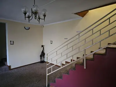 a room with stairs and a dog sitting on the wall at African Nights Barbara House in Pretoria