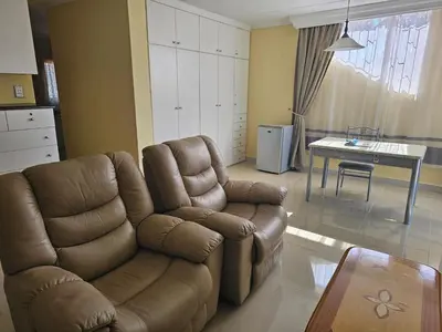 a living room with a couch and a table at African Nights Barbara House in Pretoria