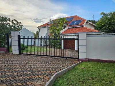 a black fence in front of a house at African Nights Protea House in Pretoria