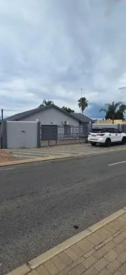 a white bus parked in front of a building at Good night guest house in Polokwane
