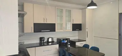 a kitchen with a black counter top and cabinets at Good night guest house in Polokwane