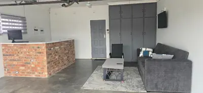 a living room with a couch and a table at Good night guest house in Polokwane