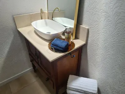 a bathroom with a sink and a mirror at Amourette's Cottages in Centurion