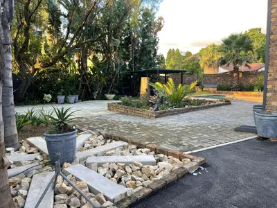 a garden with rocks and plants in a yard at Luigi's Place in Pretoria