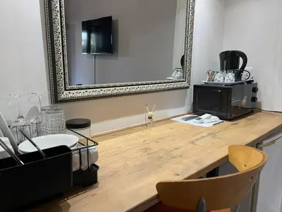 a room with a mirror and a wooden counter at Luigi's Place in Pretoria