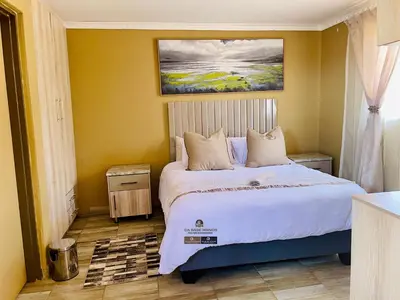 a bedroom with a bed with a painting on the wall at Dabase manor