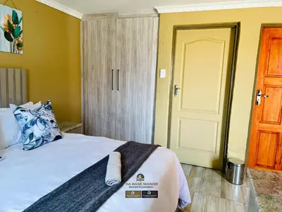 a bedroom with a bed and a door with a towel on it at Dabase manor