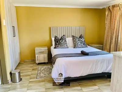 a bedroom with a bed and a yellow wall at Dabase manor