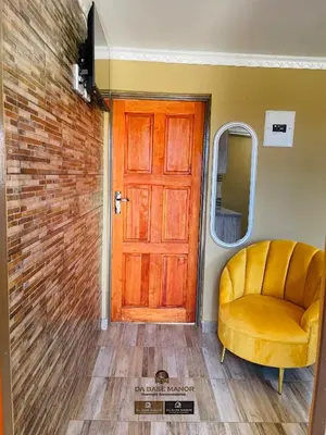 a room with a door and a yellow chair at Dabase manor