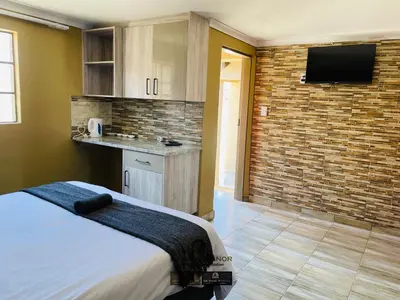 a bedroom with a bed and a brick wall at Dabase manor