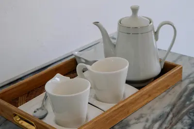 a wooden tray with cups and a tea kettle at La Grande in Benoni