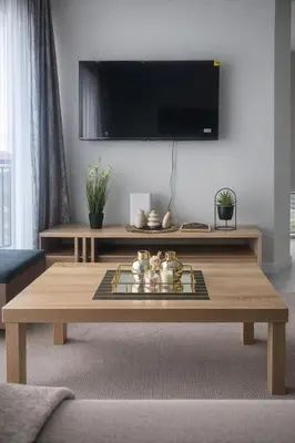 a living room with a coffee table and a tv at The Blydes Crystal Lagoon in Pretoria