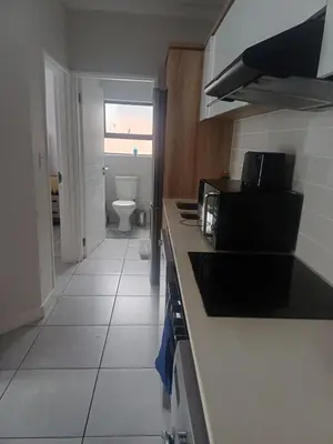 a kitchen with a sink and a toilet in a room at The Blydes Crystal Lagoon in Pretoria