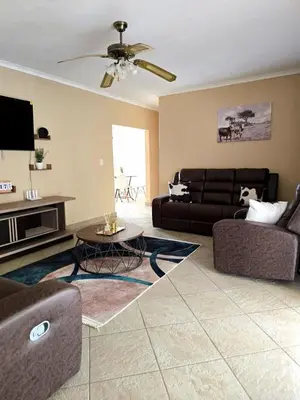 a living room with a couch and a table at Macibela2 in Bela-Bela