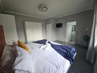 a bedroom with a bed with white sheets and pillows at Lula Guest house 14km to Kriel power station in Kriel