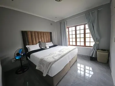 a bedroom with a large bed and a window at Lula Guest house 14km to Kriel power station in Kriel