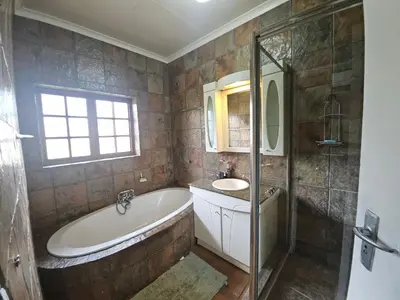 a bathroom with a tub and a sink at Lula Guest house 14km to Kriel power station in Kriel