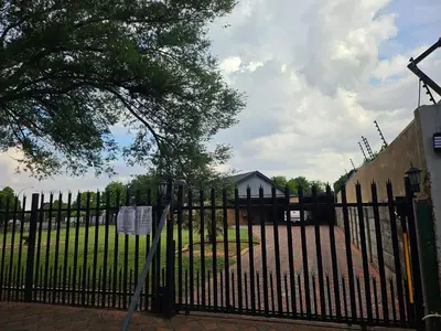 a black fence with a sign in front of it at Lula Guest house 14km to Kriel power station in Kriel