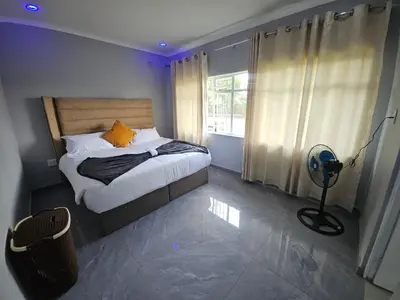 a bedroom with a bed with a yellow pillow and a window at Lula Guest house 14km to Kriel power station in Kriel