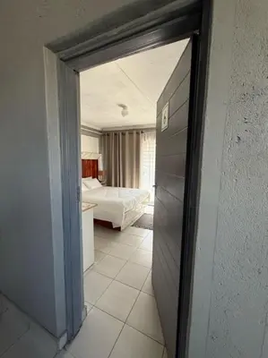 an open door to a room with a bedroom at Amai Guesthouse in Thohoyandou