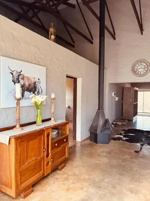 a living room with a fireplace and a wood stove at Schaapkraal Cottages in Weimershoek