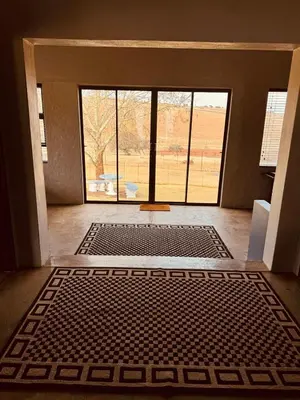 a room with an open door with a large window at Schaapkraal Cottages in Weimershoek