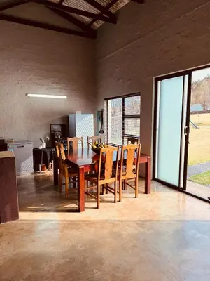 a dining room with a table and chairs at Schaapkraal Cottages in Weimershoek