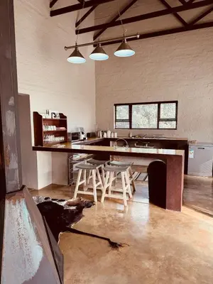 a kitchen with a table and chairs in a room at Schaapkraal Cottages in Weimershoek