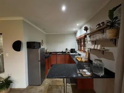 a kitchen with a refrigerator and a counter top at EquiRest Horse & Human Country Stay in Midrand