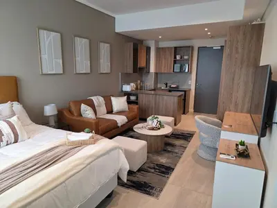 a bedroom with a bed and a living room at Studio in Menlyn Maine in Pretoria