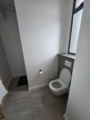 a small bathroom with a toilet with a window at Studio in Menlyn Maine in Pretoria