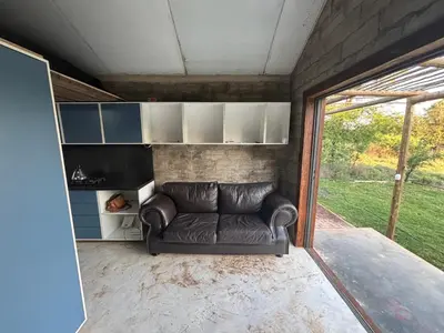 a leather couch sitting in the middle of a room at Bosch Rest in Pretoria