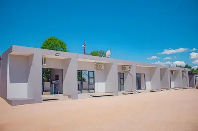 a large white building with a cross on the roof at Dzire Guesthouse in Thohoyandou