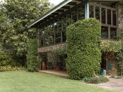a building with a large bush in front of it at Magoebaskloof Mountain Estate in Tzaneen