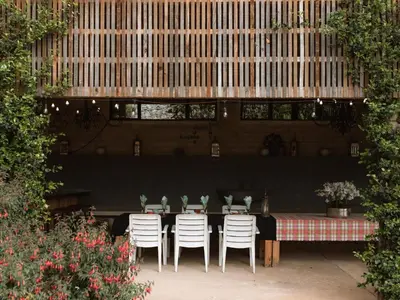 a table and chairs in a patio with a table and a table and chairs at Magoebaskloof Mountain Estate in Tzaneen