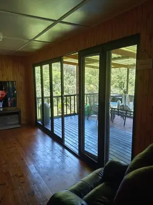 a living room with sliding glass doors on a deck at Barberton Troop Cabin in Barberton
