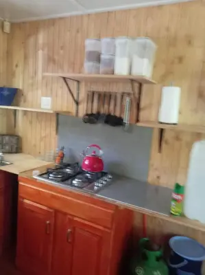 a kitchen with a stove with a tea pot on it at Barberton Troop Cabin in Barberton