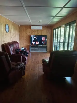 a living room with two couches and a television at Barberton Troop Cabin in Barberton
